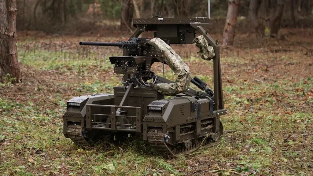 Droid TW 12.7 tracked ground robot mounting a heavy machine gun in a forest