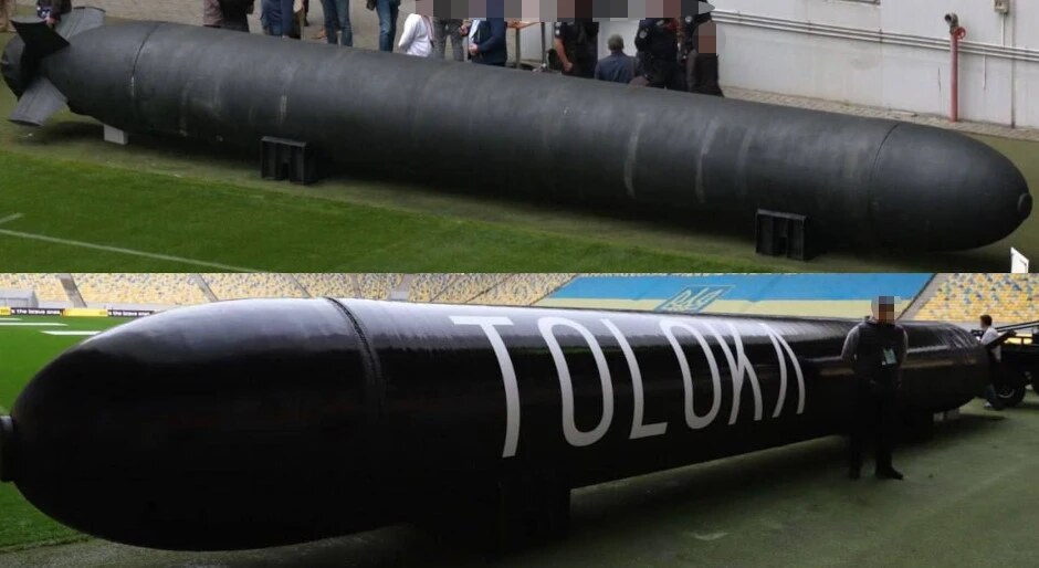 TLK-1000 unmanned underwater vehicle displayed on a stadium field, showing its full length